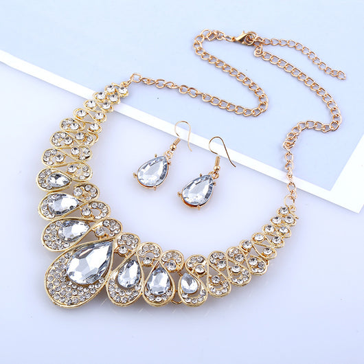 Gold-tone necklace and matching drop earrings set with clear teardrop gems and sparkling rhinestones. - Image 6