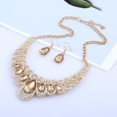 Gold-tone necklace and matching drop earrings set with clear teardrop gems and sparkling rhinestones. - Image 4
