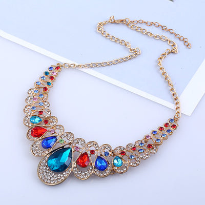 Gold-tone necklace and matching drop earrings set with clear teardrop gems and sparkling rhinestones. - Image 5