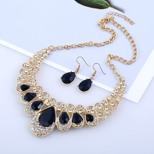 Gold-tone necklace and matching drop earrings set with clear teardrop gems and sparkling rhinestones.