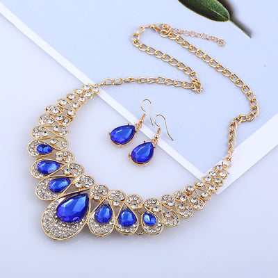 Gold-tone necklace and matching drop earrings set with clear teardrop gems and sparkling rhinestones. - Image 3