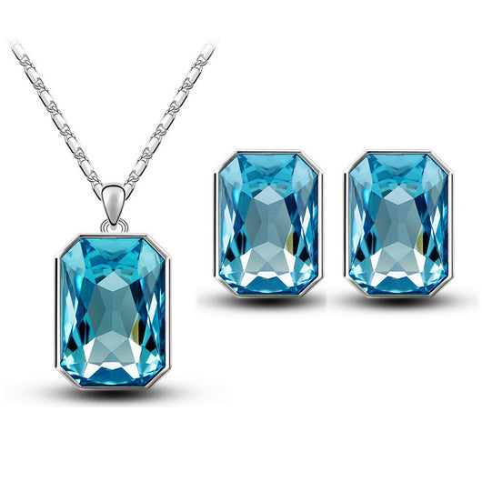 Teal rectangular crystal necklace and matching stud earrings set with silver-toned settings and chain. - Image 2