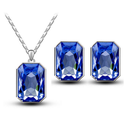 Teal rectangular crystal necklace and matching stud earrings set with silver-toned settings and chain. - Image 16