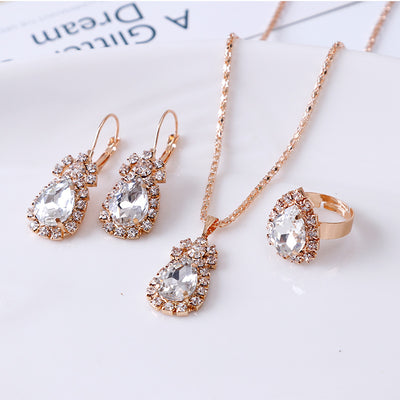 Red teardrop rhinestone necklace, matching dangle earrings, and adjustable ring set in gold-tone metal. - Image 6