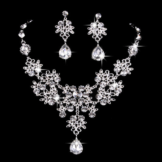 Purple crystal necklace and earring set with butterfly and floral designs, featuring large teardrop pendants.