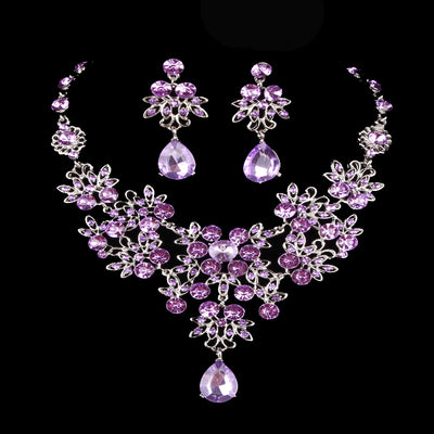 Purple crystal necklace and earring set with butterfly and floral designs, featuring large teardrop pendants. - Image 3