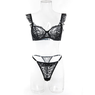 Black sheer lace lingerie set with floral patterns, including an underwire bra and matching thong, on pink satin. - Image 14