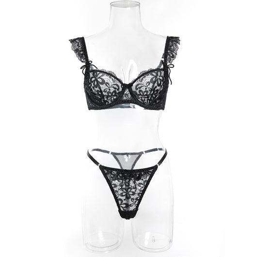 Black sheer lace lingerie set with floral patterns, including an underwire bra and matching thong, on pink satin. - Image 14