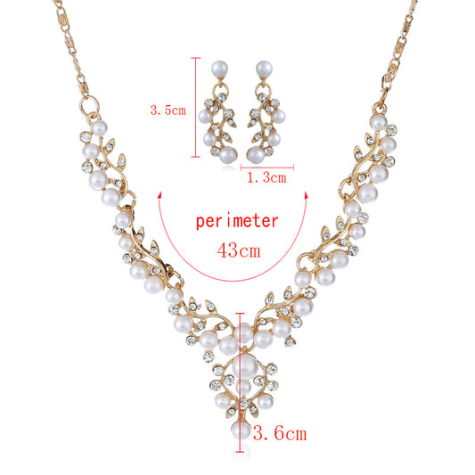 Gold-toned necklace and matching stud earrings set with vine-like design, adorned with white faux pearls and clear rhinestones. - Image 2