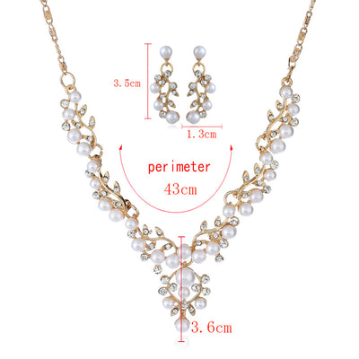 Gold-toned necklace and matching stud earrings set with vine-like design, adorned with white faux pearls and clear rhinestones. - Image 2
