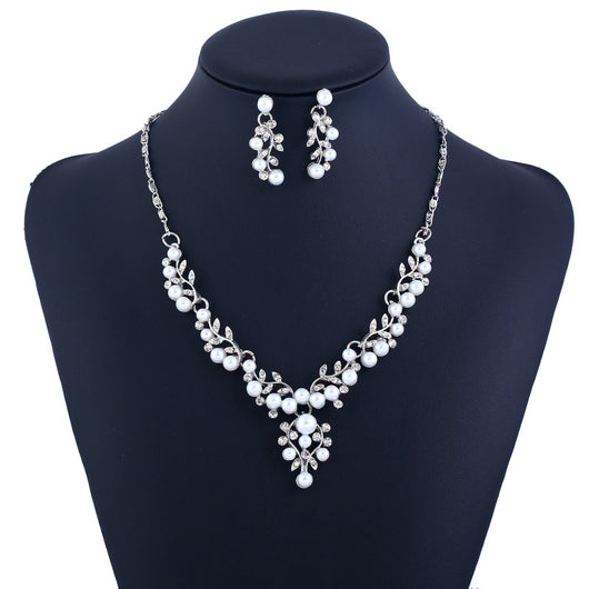 Gold-toned necklace and matching stud earrings set with vine-like design, adorned with white faux pearls and clear rhinestones. - Image 3