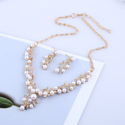 Gold-toned necklace and matching stud earrings set with vine-like design, adorned with white faux pearls and clear rhinestones. - Image 5
