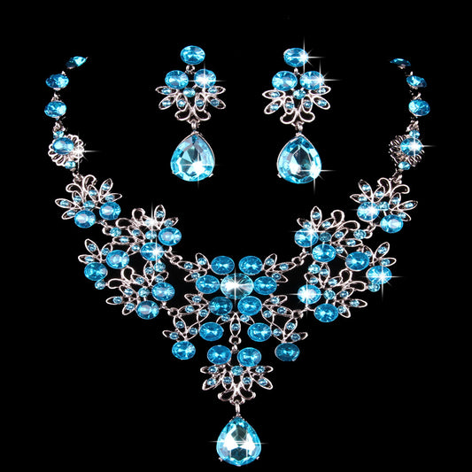 Purple crystal necklace and earring set with butterfly and floral designs, featuring large teardrop pendants. - Image 2