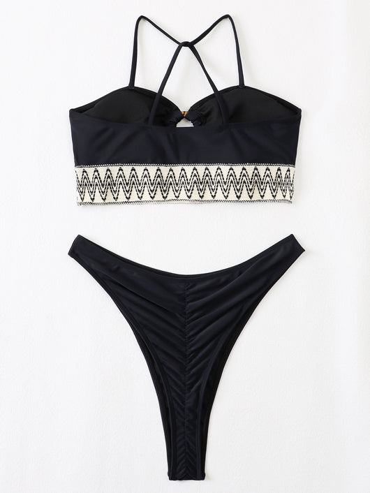 Black two-piece swimsuit with a bandeau top featuring a central O-ring, cut-out, and white zigzag embroidered trim, paired with matching high-cut bikini bottoms - Image 5