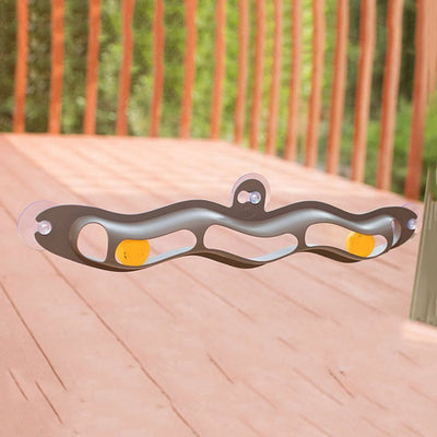 Grey plastic wavy track ball cat toy with two orange balls and suction cups for window or wall mounting. - Image 3