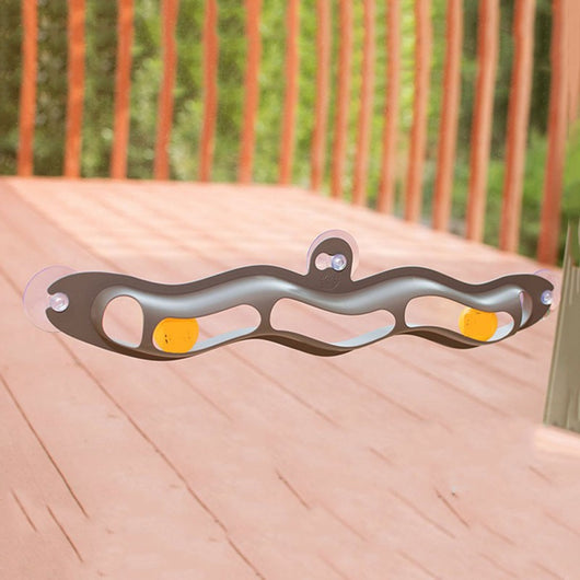 Grey plastic wavy track ball cat toy with two orange balls and suction cups for window or wall mounting. - Image 3