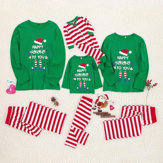 Family Christmas pajamas set with green long-sleeve tops featuring an elf print and 'HAPPY HOHOHO TO YOU' text, paired with red and white striped bottoms.