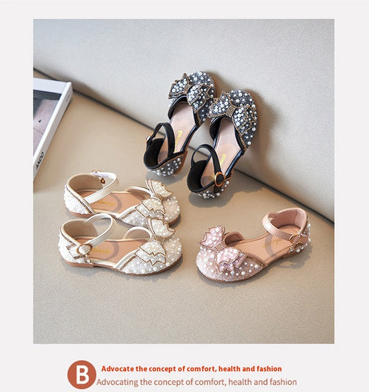 Beige girls' shallow mouth pumps with a large pink pearl bow, glitter, and an ankle strap with a gold buckle. - Image 13