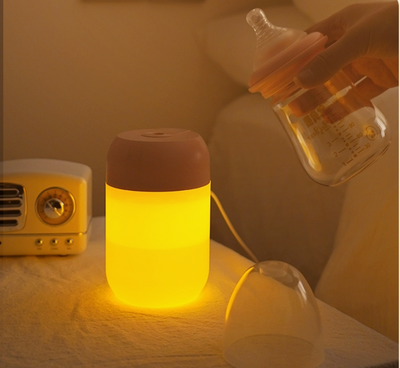 White cylindrical mini humidifier with a soft yellow glow, suitable for air moisturizing and aromatherapy, USB powered. - Image 4