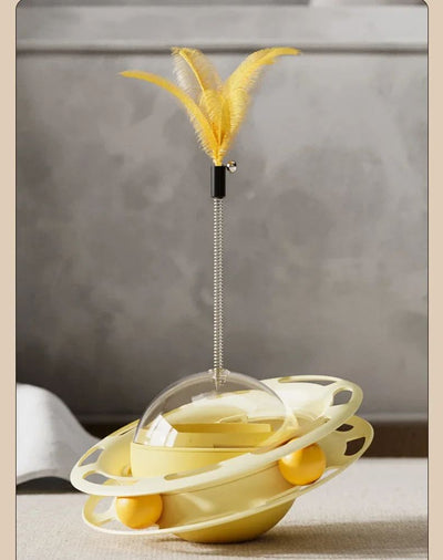 Yellow UFO tumbler cat toy with rolling balls, a clear dome, and a spring-mounted feather wand with a bell. - Image 23