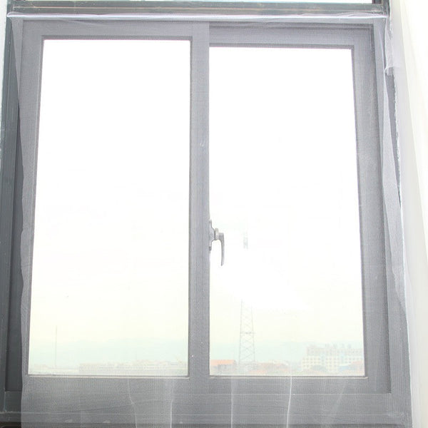 White self-adhesive mosquito screen applied to a gray window frame, offering clear visibility to the outside.