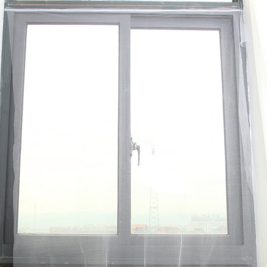 White self-adhesive mosquito screen applied to a gray window frame, offering clear visibility to the outside.