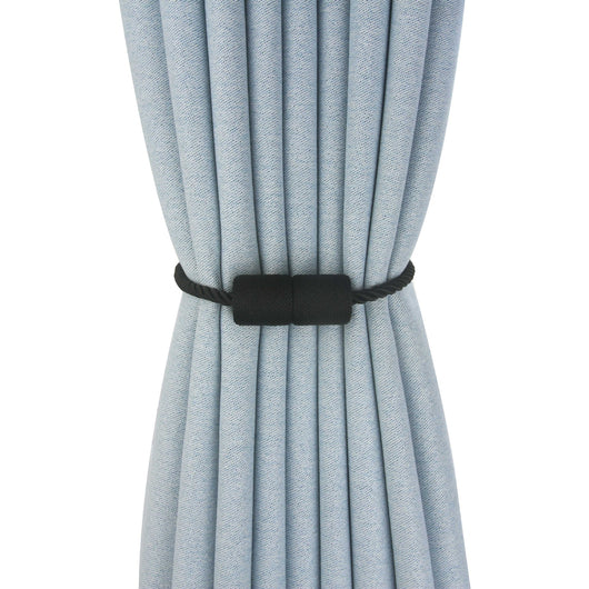 Black cylindrical magnetic curtain tieback holding a light blue pleated curtain, against a clean white background. - Image 9
