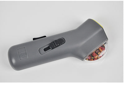 Dog Treat Launcher in retail packaging, a gray handheld device for dispensing snacks during training or playtime. - Image 6