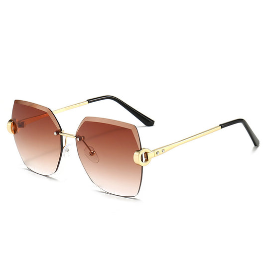 Woman wearing oversized hexagonal rimless sunglasses with gradient lenses and a black leather newsboy cap. - Image 5