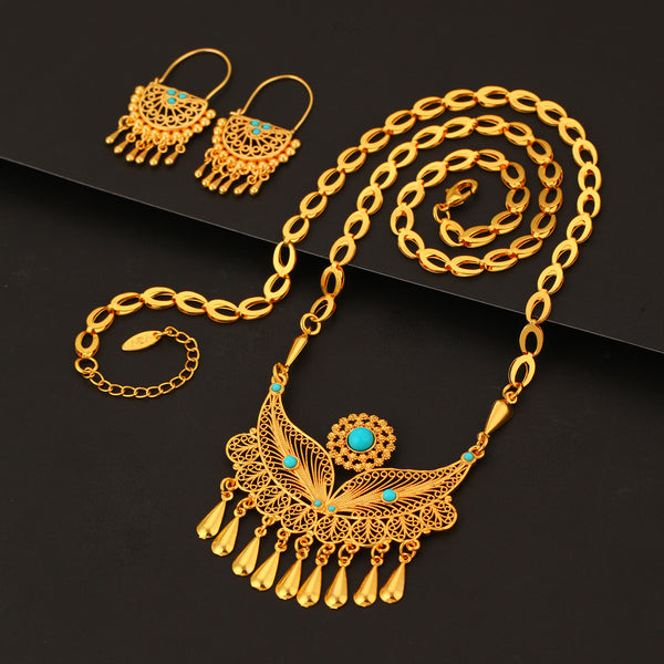 Gold-toned necklace and dangle earrings set with filigree water droplet design, turquoise accents, and tassel charms.