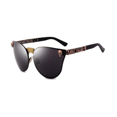 Pink mirrored cat-eye sunglasses with gold-toned frames, skull, and floral embellishments on the temples. - Image 12