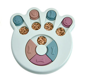 Paw-shaped dog puzzle feeder toy in light yellow with colorful sliding covers, filled with kibble. - Image 18