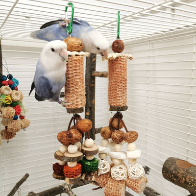 Hanging parrot chew toy made from natural wood slices, corncob, vine balls, and colorful textured blocks.