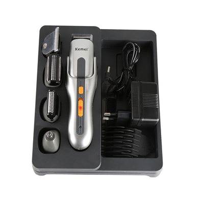 Kemei multi-function hair clipper set with silver and black body, orange buttons, and multiple interchangeable heads on a black charging base. - Image 3
