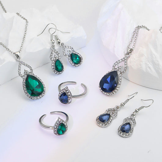 Light luxury jewelry set with silver-tone necklace, dangle earrings, open ring, and bracelet, all featuring emerald green teardrop and oval stones with clear rh - Image 4