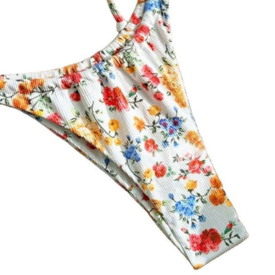 Women's white floral two-piece bikini with red, orange, and blue flowers, featuring a tie-front top and tie-side bottoms. - Image 13