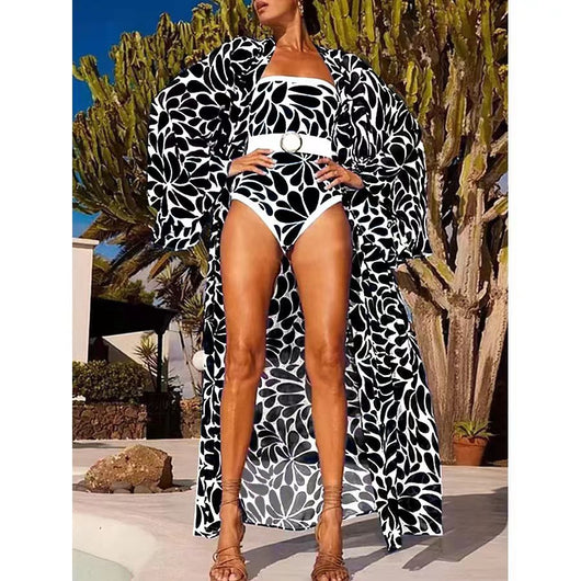 Woman in black and white floral print one-piece swimsuit with matching long-sleeved kimono cover-up and white belt. - Image 6