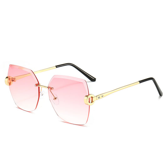 Woman wearing oversized hexagonal rimless sunglasses with gradient lenses and a black leather newsboy cap. - Image 12