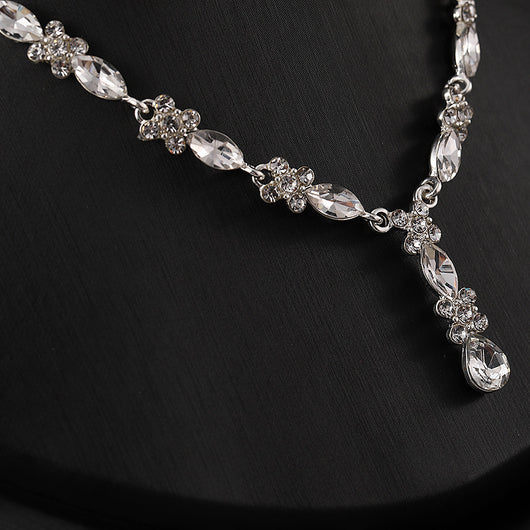 Elegant silver-tone necklace and matching drop earrings set with clear marquise and teardrop stones, displayed on a black bust. - Image 3