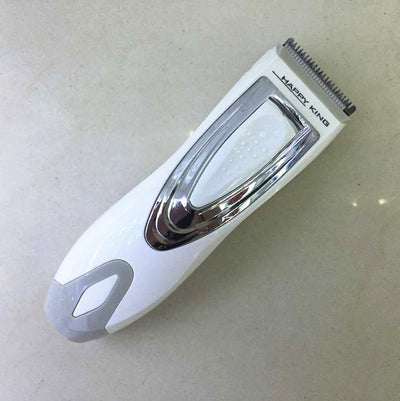 White and silver electric hair clipper held in hand, with a grey guide comb and blue packaging on a woven surface. - Image 5