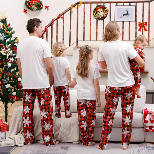 Family of five wearing matching Christmas pajamas with white 'Cousin Crew' tops and red plaid snowflake pants. - Image 4