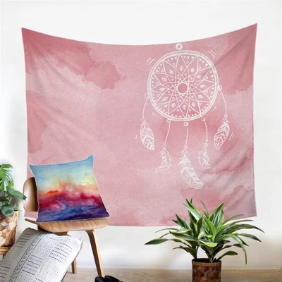Pink watercolor-style wall tapestry with a white dreamcatcher design and hanging feathers, displayed in a room.