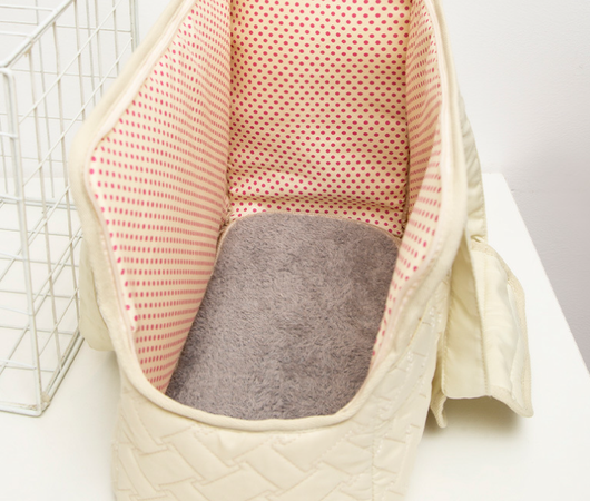 Cream quilted portable pet carrier with top handles, detachable shoulder strap, front pocket, and ventilation mesh. - Image 10