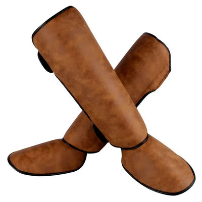 Pair of brown and black thickened shin guards for fighting and boxing, featuring a distressed leather-like texture. - Image 3
