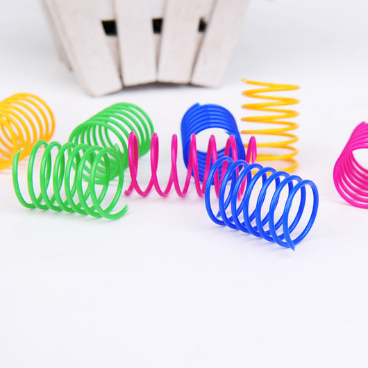 Four colorful plastic spring cat toys in green, blue, orange, and pink, packaged in a clear plastic bag. - Image 2