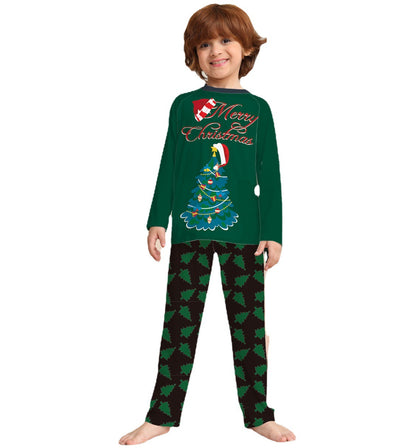 Family of four wearing matching green Christmas pajamas with "Merry Christmas" text and tree graphics. - Image 5