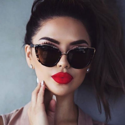 Ladies retro cat eye sunglasses with a tortoiseshell frame, gold accents, and brown gradient lenses.