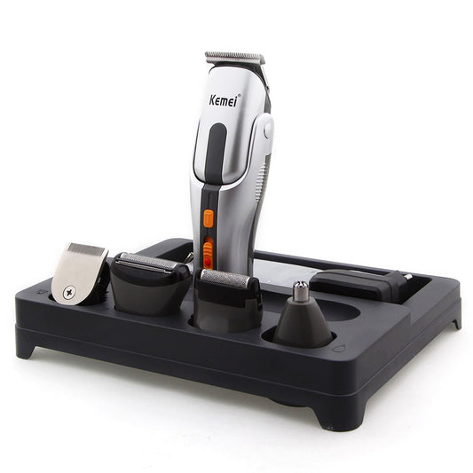 Kemei multi-function hair clipper set with silver and black body, orange buttons, and multiple interchangeable heads on a black charging base.
