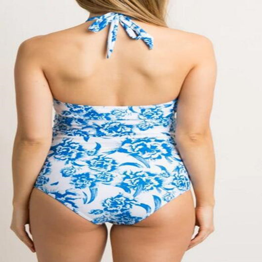 Women's blue and white floral print halter neck tankini top with ruched bottoms on a sandy beach. - Image 3