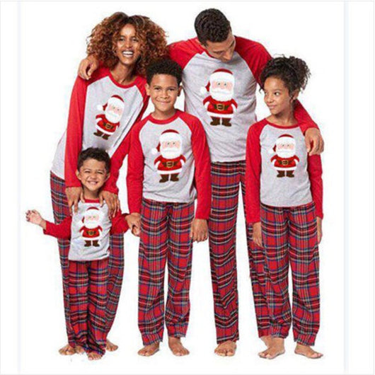 Young boy wearing a Christmas pajama set with a grey Santa Claus raglan shirt and red plaid pants. - Image 4